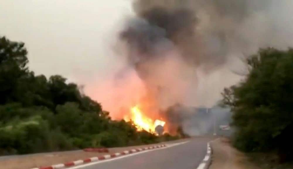 A photo grab from video footage shows a fire raging in Algeria's El Tarf province on August 17, 2022