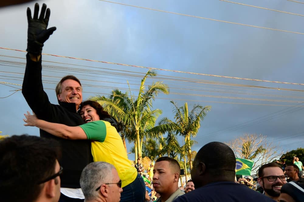 Brazilian President Jair Bolsonaro (R) is seeking a second term in October 2022 presidential elections