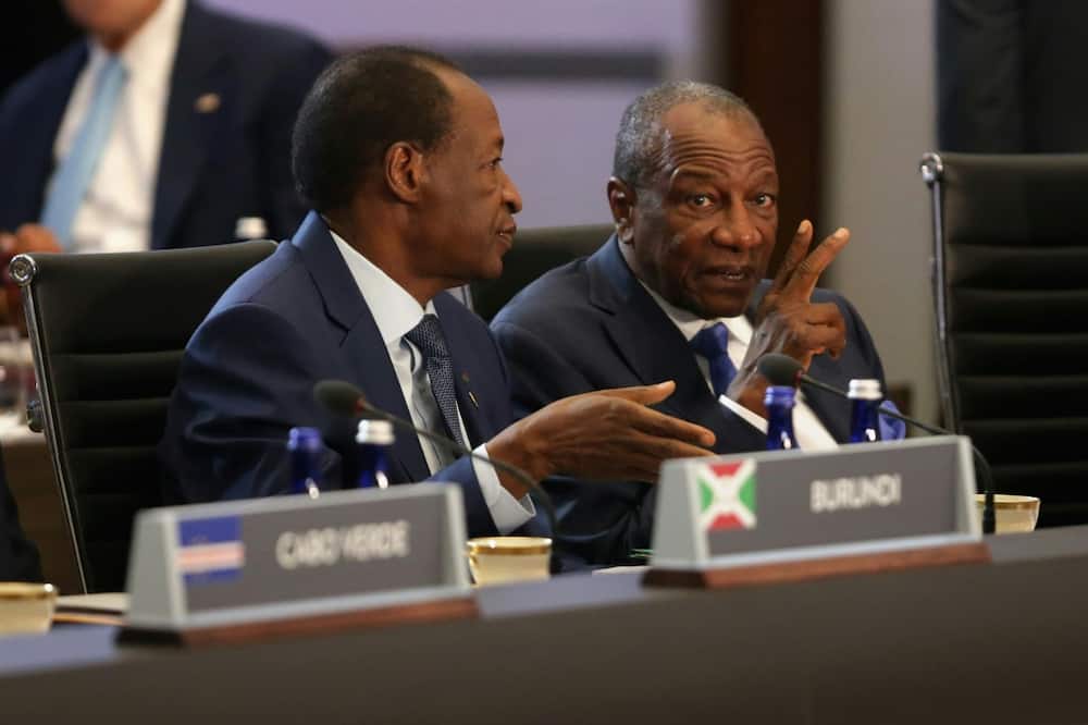 Burkina Faso's former president Blaise Compaore (L) talks with Guinean counterpart Alpha Conde before the first plenary meeting of the US-Africa Leaders Summit at the State Department in August  2014 in Washington, DC.