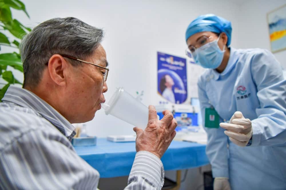 China's low vaccination rates, particularly among  older adults, are seen as prolonging Beijing's no-tolerance approach to Covid