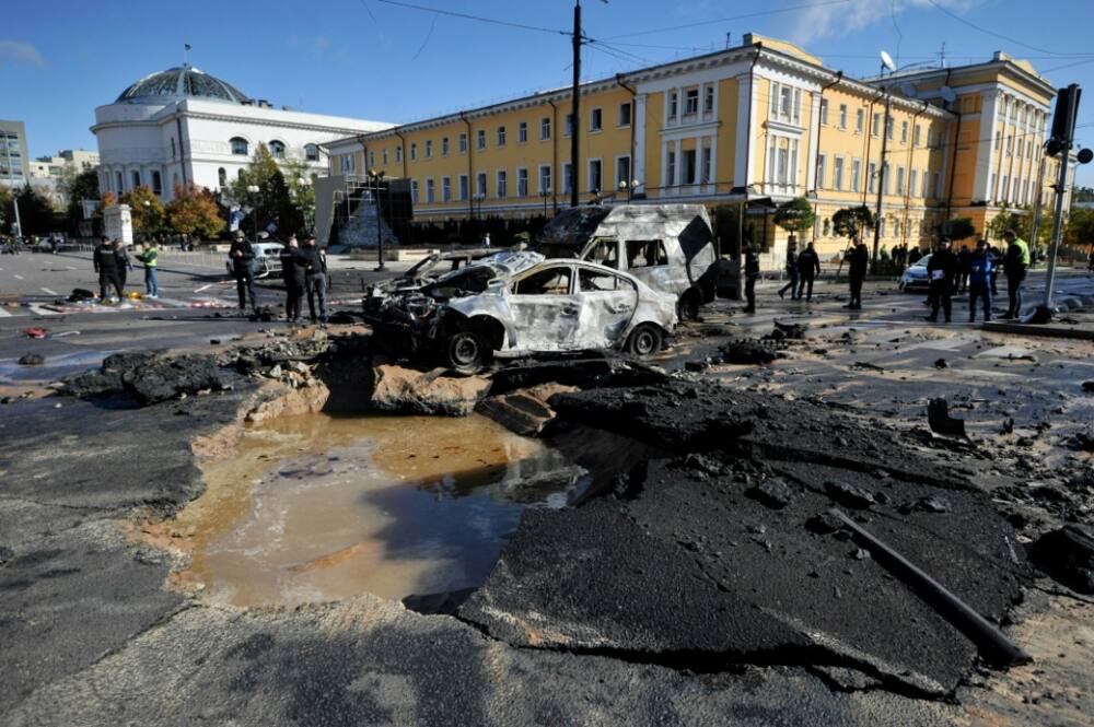 Police examine the destruction in central Kyiv after several Russian strikes