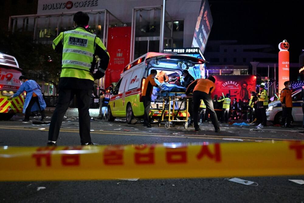 Yellow-jacketed policemen formed a cordon around the site of a deadly crush in the Itaewon neighborhood in Seoul