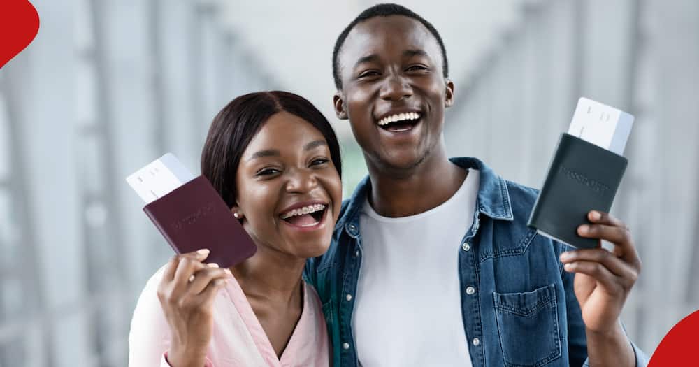 Joyful Emotional African Couple Holding Passports And Tickets - stock photo.