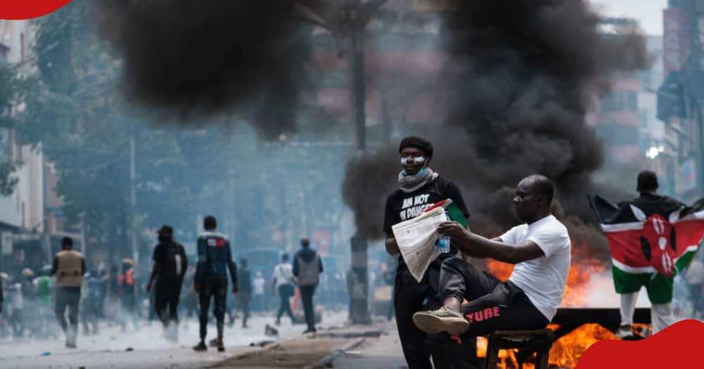 A Kenyan protester reads newspaper.