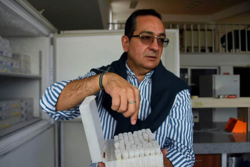 Ecuadoran scientist Javier Carvajal shows vials containing the resurrected strain of yeast from Latin America's oldest beer