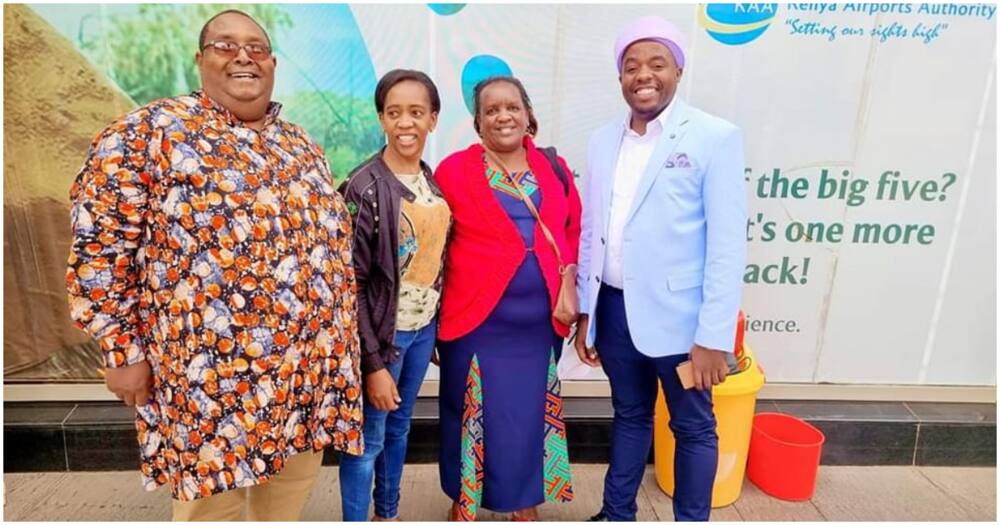 Reverend Francis Gichuru posing for a picture with his wife and friends.