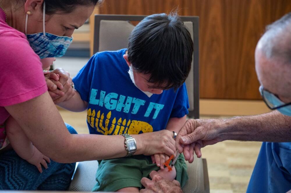 A three year old receives his Covid-19 vaccination, with Moderna, at Temple Beth Shalom in Needham, Massachusetts on June 21, 2022