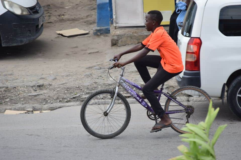Mombasa boy warms hearts after putting bicycle aside to help elderly man cross road