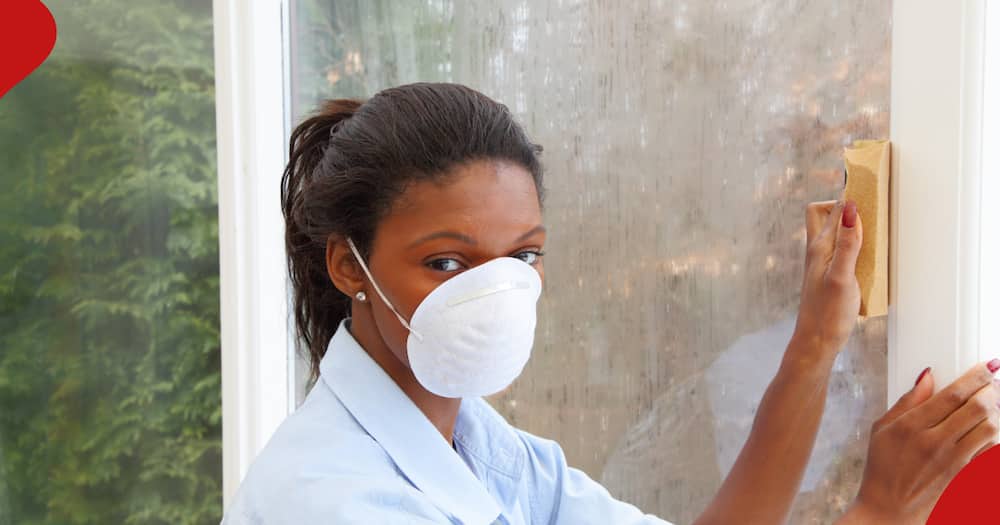 Photo of a domestic worker cleaning window used gor illustration