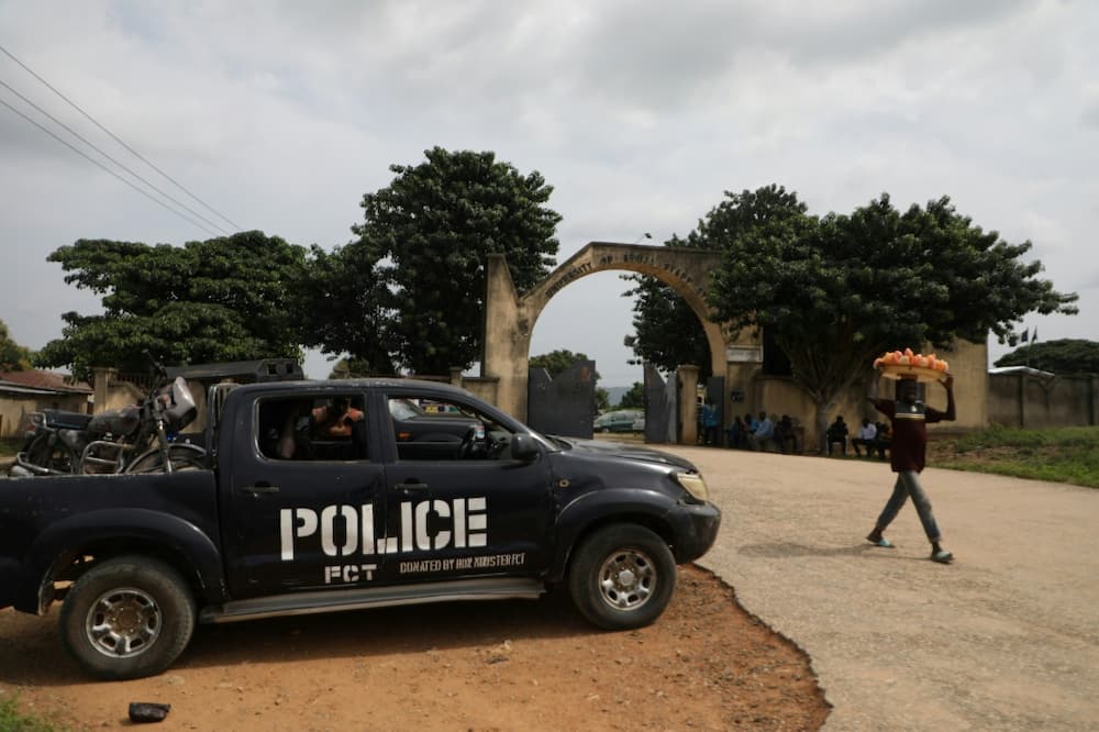 A police truck stands outside the University of Abuja staff Quarters gate where gunmen kidnapped university professors, lecturers and family members on November 2, 2021
