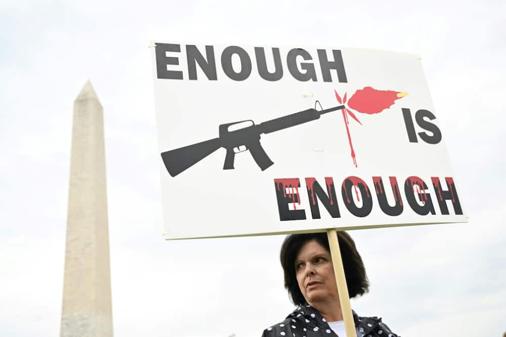 A gun control advocate holds a sign during a June 11, 2022 protest in Washington, DC that was organized by March for Our Lives