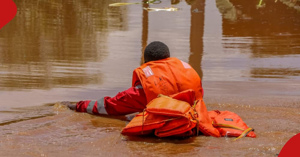 Kenya Red Cross official on a rescue mission on Wednesday following flooding in Mathare.