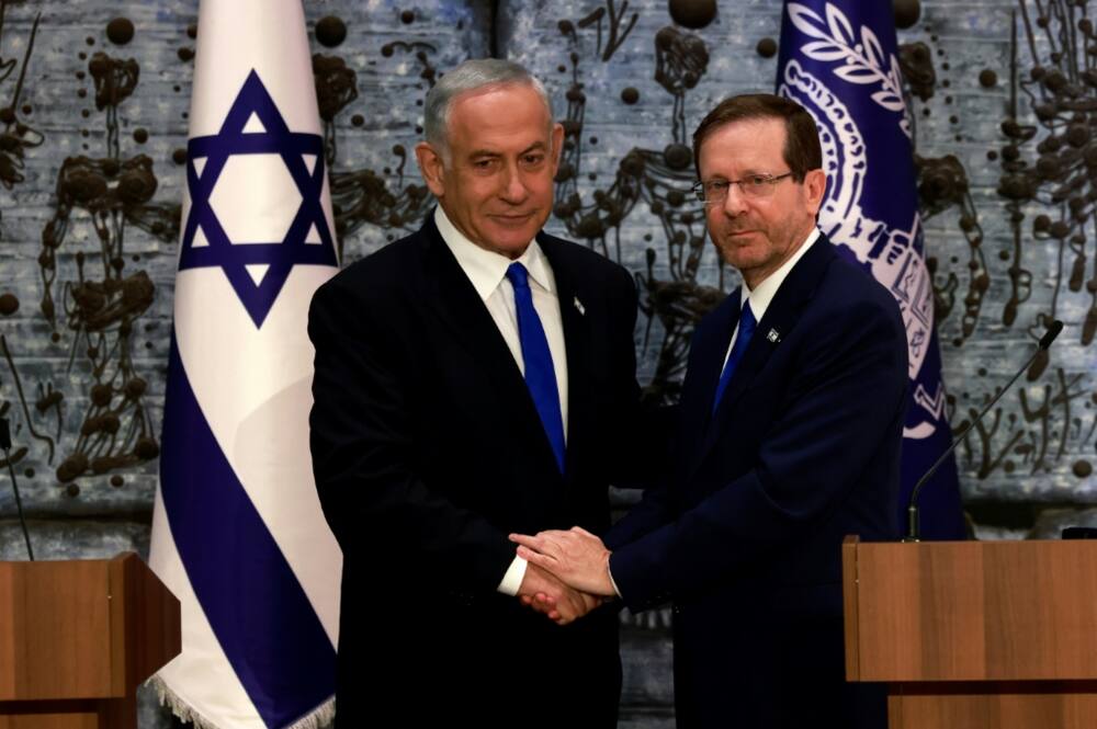 Israeli ex-premier Benjamin Netanyahu, on the left, was mandated with forming a new government by President Isaac Herzog