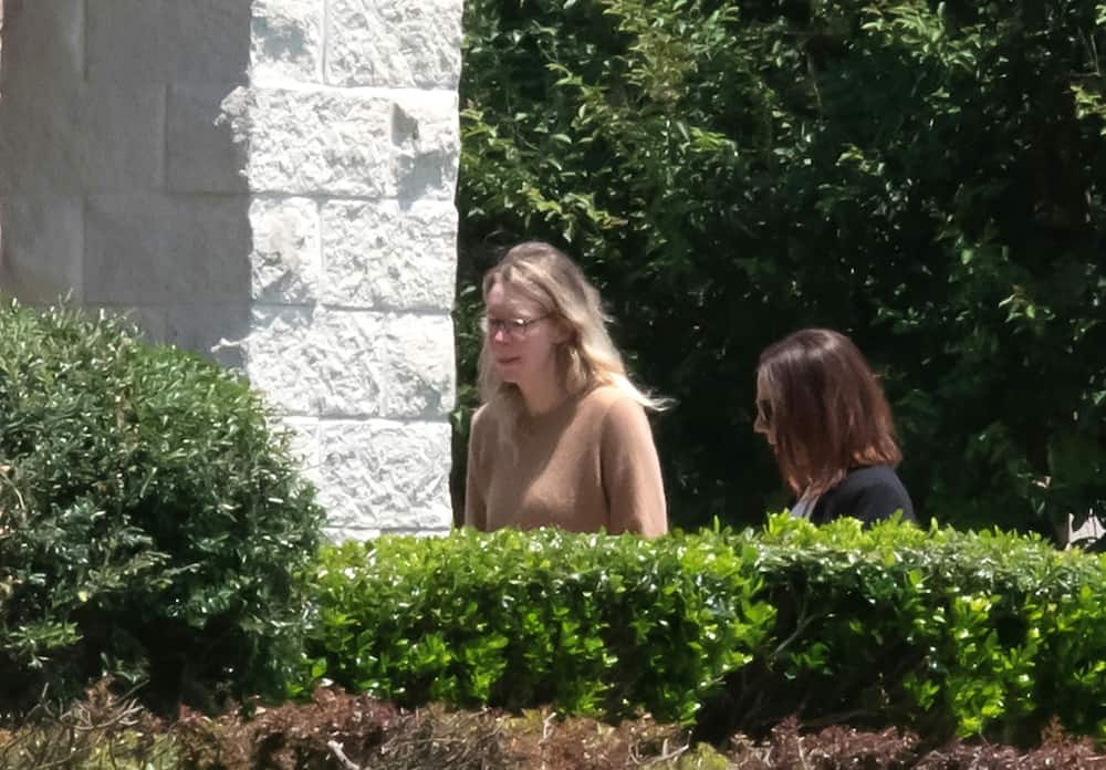 Theranos founder Elizabeth Holmes (L) arrives at a federal prison in Bryan, Texas to begin her sentence