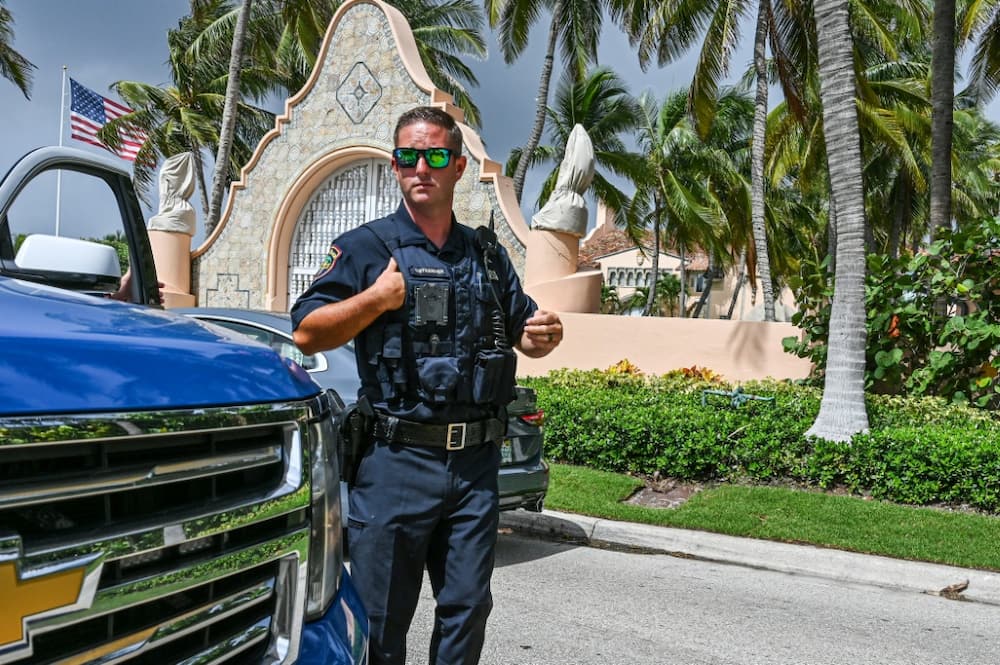 Local law enforcement officers in front of the Mar-a-Lago home of former president Donald Trump in Palm Beach, Florida