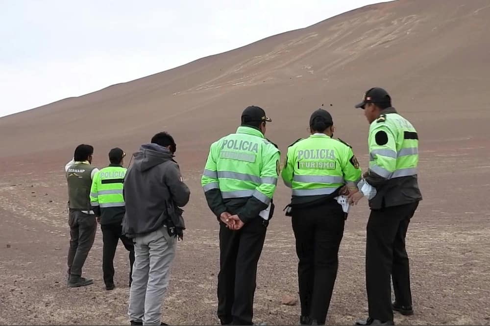 A frame grab from a video courtesy of the Peruvian Ministry of Culture shows police examining the damage at the Paracas Candelabra