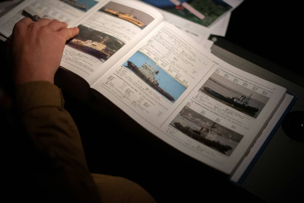 Reference books help identify ships observed from the sky