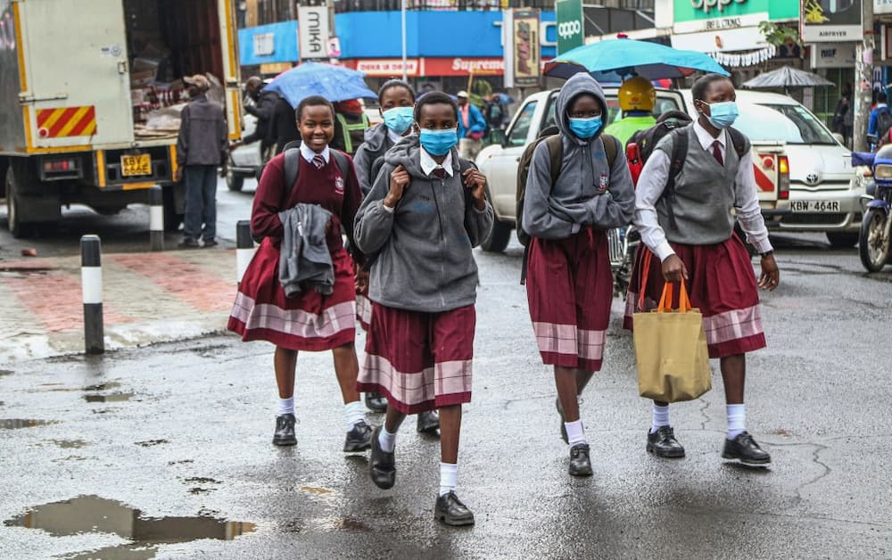 Kenyan students are seen crossing a busy road
