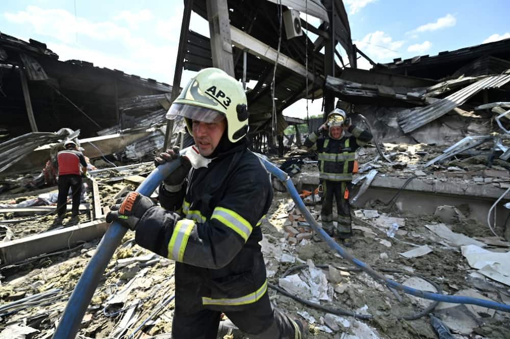 Rescuers clear rubble from a mall in Kremenchuk, on June 28, 2022, one of a series of Russian attacks that have led Ukraine to urge the West to label Moscow a "state sponsor of terrorism"