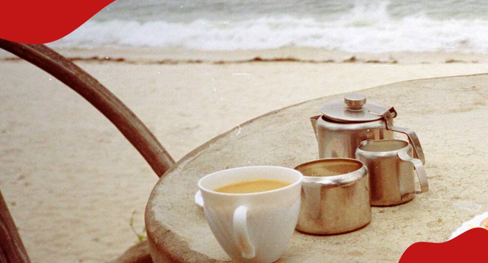 Cup of tea close to a beach.