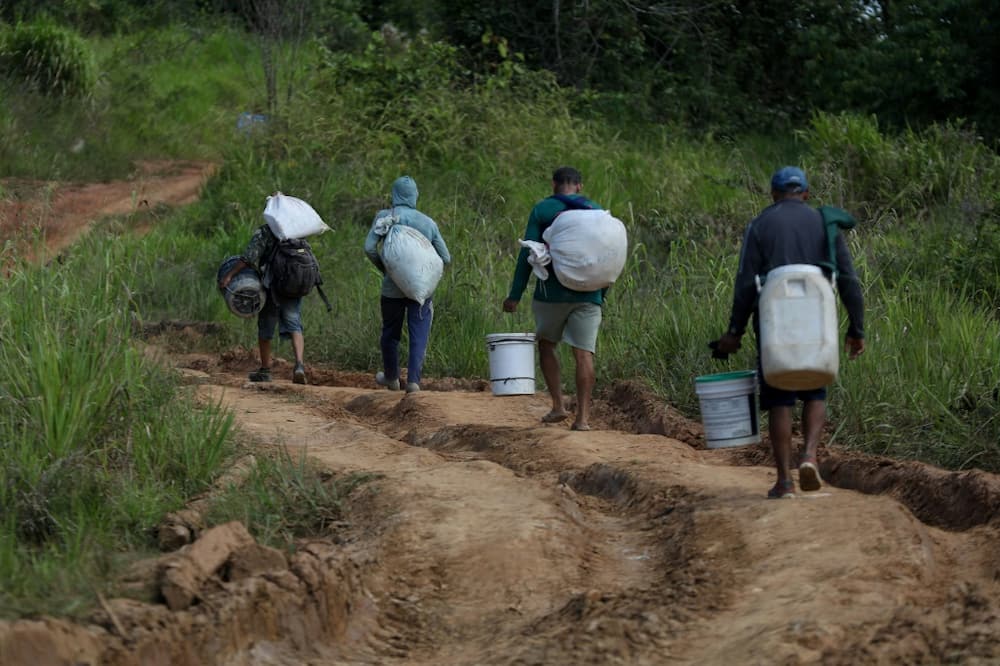 Alleged illegal miners leave a mining area inside Yanomami indigenous land