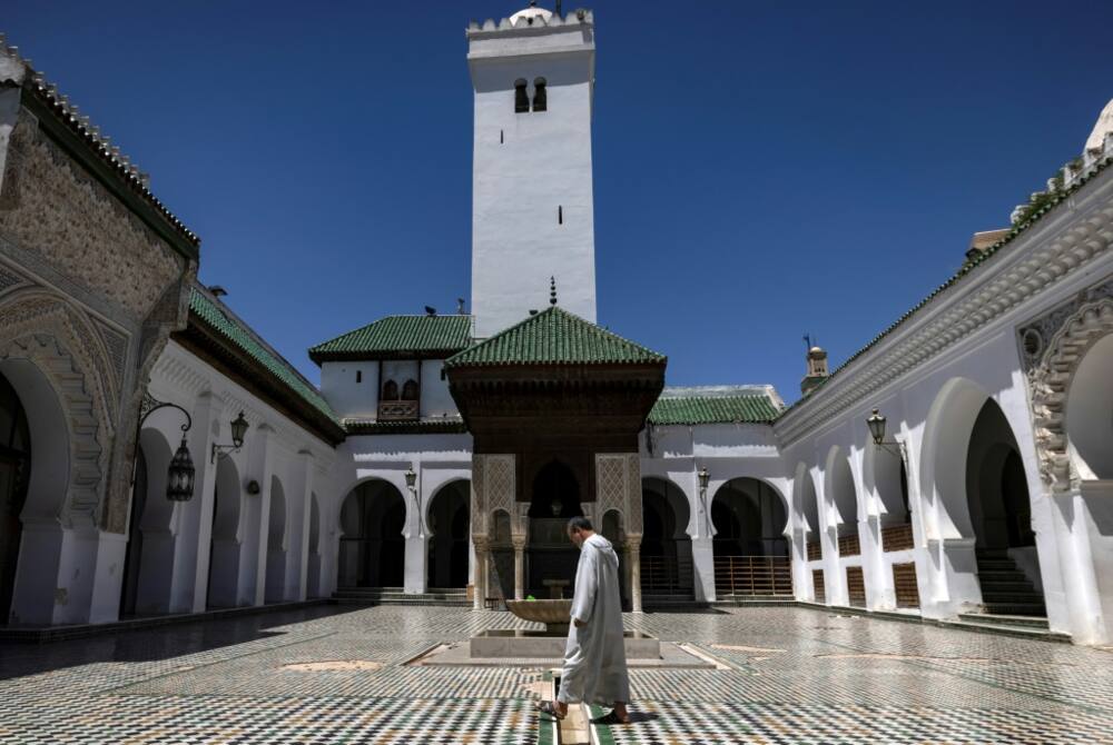A man walks across courtyard of Qarawiyyin mosque
