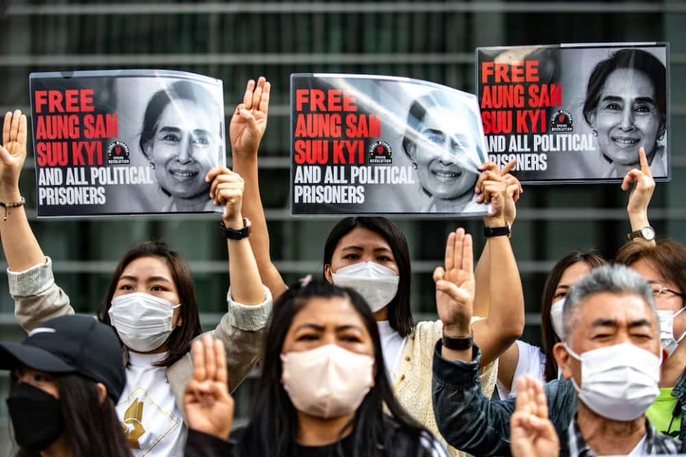 A group of Myanmar activists in Tokyo hold up placards calling for the release of their ousted leader Aung San Suu Kyi in May 2022