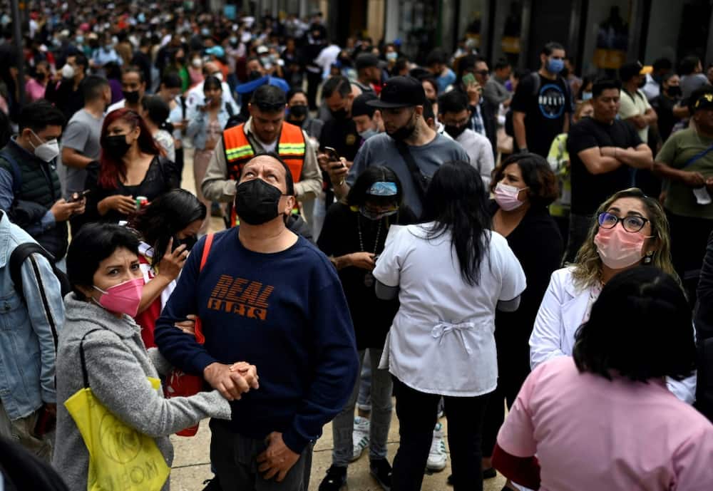 People wait on the streets of Mexico City after a powerful earthquake