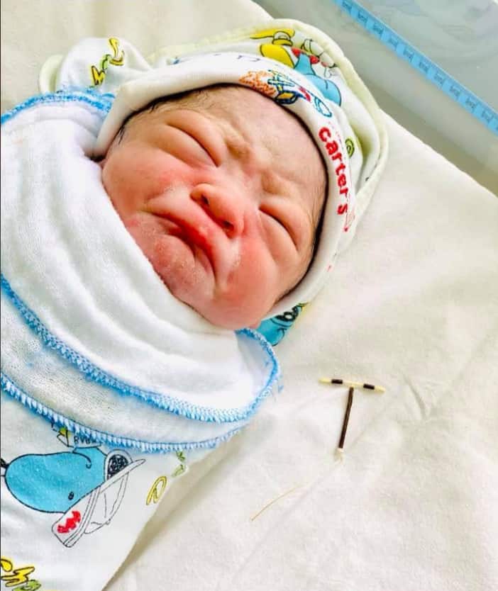 Defiant baby born holding mum's failed IUD in his hand