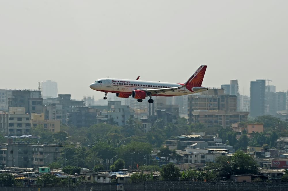 A sacked executive of US banking giant Wells Fargo is accused of urinating on a fellow passenger aboard an Air India flight
