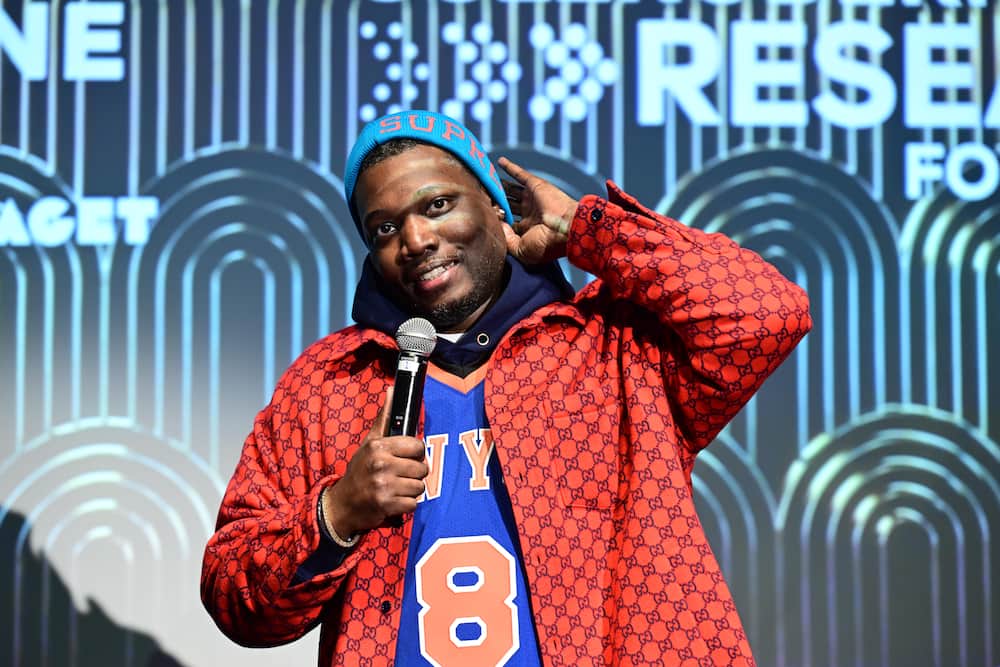 Michael Che performs onstage