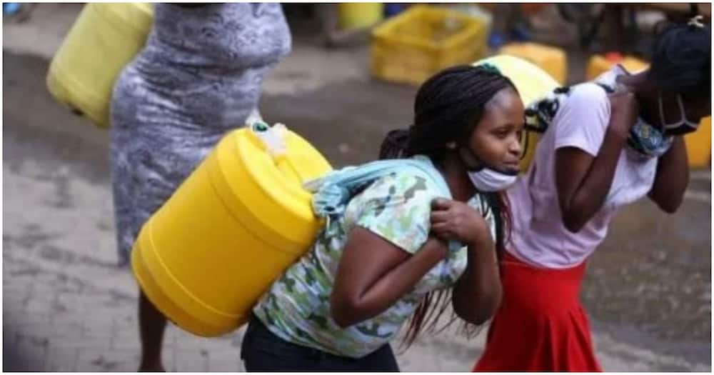 Women carrying water jerricans.