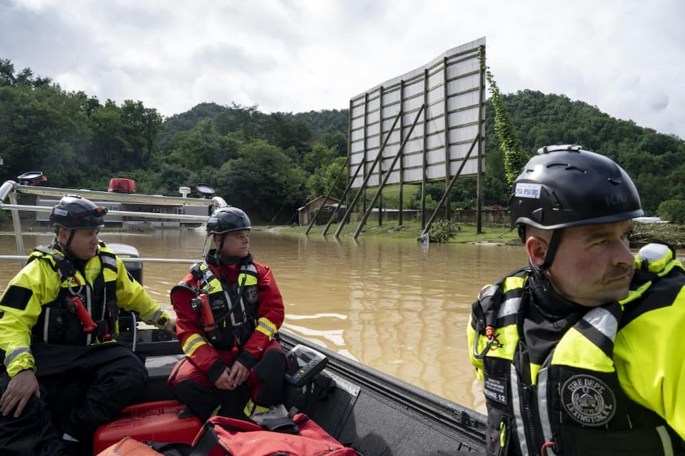 Firefighters head out to  rescue people stranded by flooding in Lost Creek, Kentucky