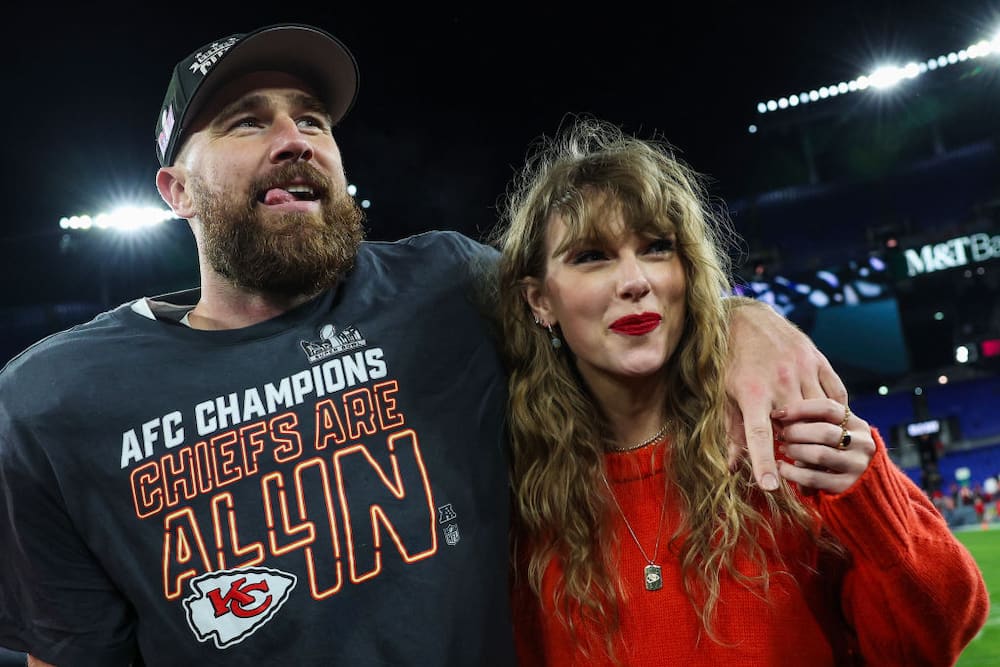 Travis Kelce #87 of the Kansas City Chiefs (L) celebrates with Taylor Swift after defeating the Baltimore Ravens in the AFC Championship Game