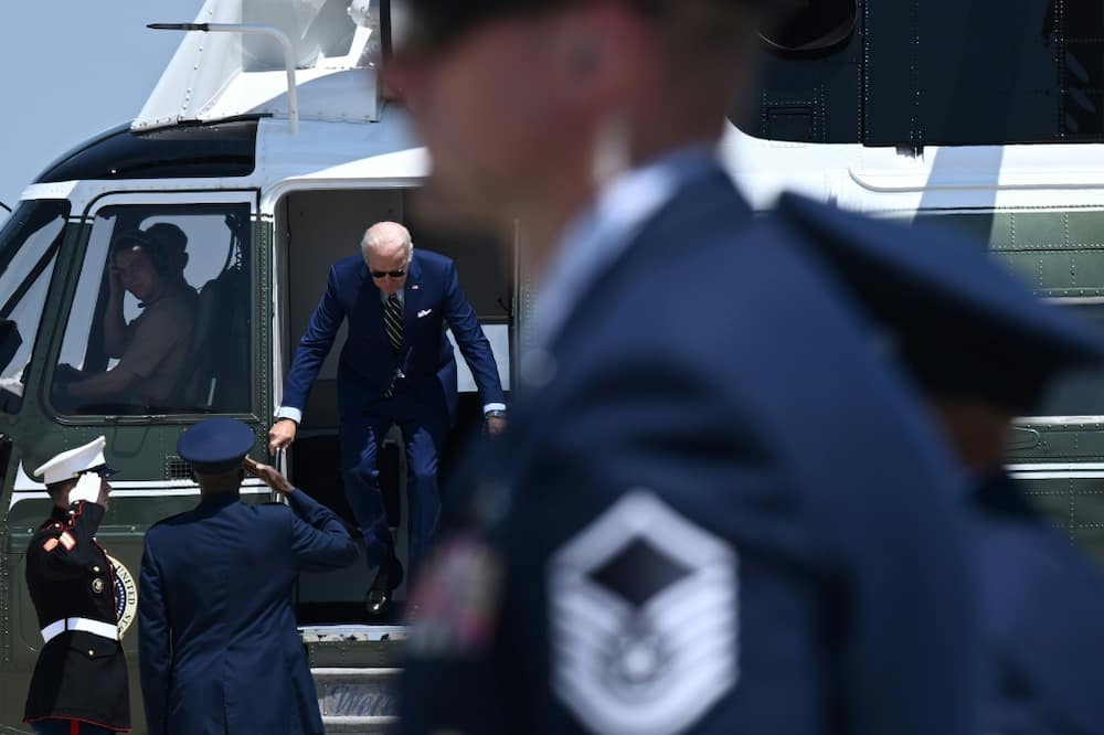 US President Joe Biden disembarks Marine One prior to boarding Air Force One at Joint Base Andrews in Maryland on July 20, 2022