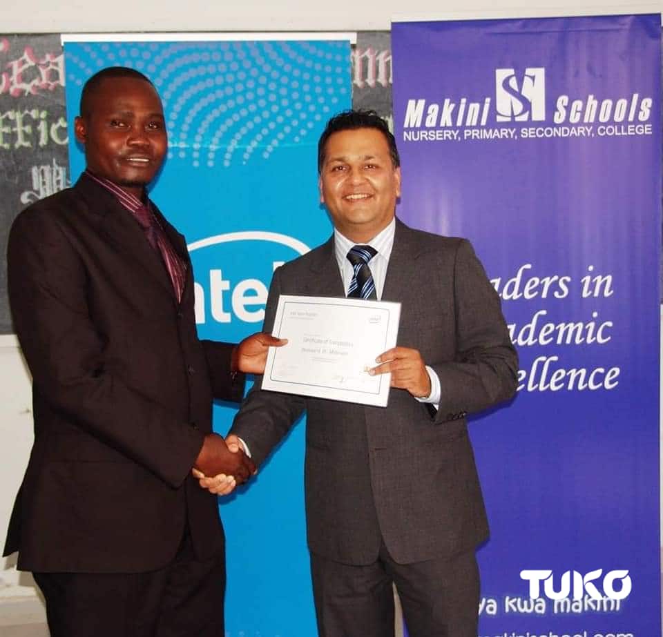 Bernard Mbeya (left) receives a certificate.
