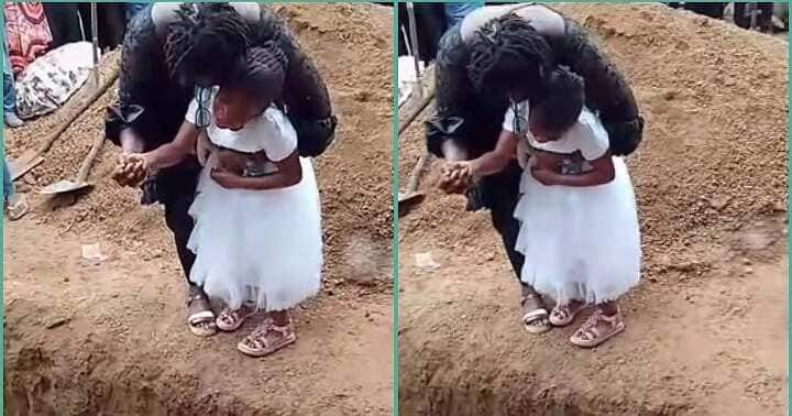 Little girl cries bitterly at her mother's graveside