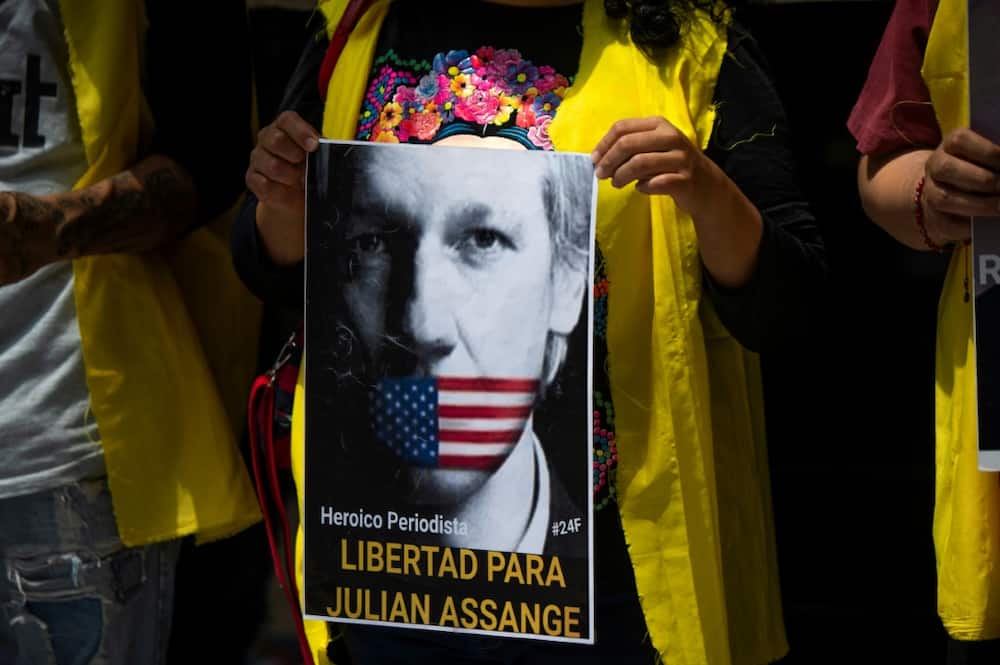 A woman holds a poster depicting WikiLeaks founder, Australian Julian Assange, reading “heroic journalist. Freedom for Julian Assange”, during a protest outside the British embassy in Mexico City, on June 18, 2022