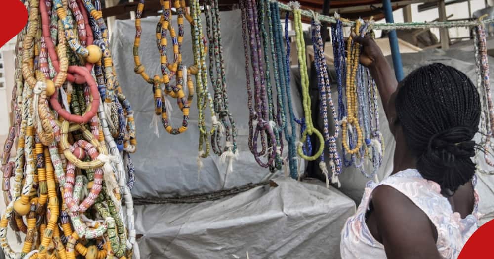 A picture of a black girl selecting waist beads.