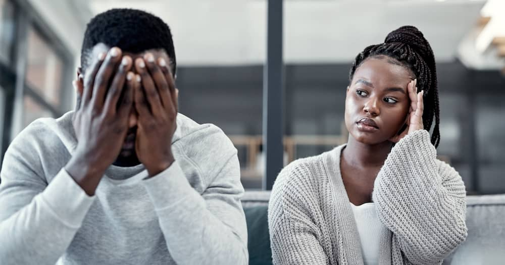 Shot of a young couple ignoring each other after having an argument on the sofa at home. Photo: Getty Images.