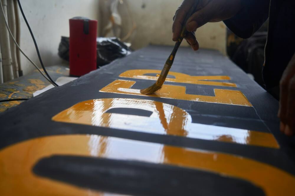 Victor Ndlovu works on Netherlands' batsman Tom Cooper's name tag ahead of their T20 World Cup qualifier agaisnt Zimbabwe