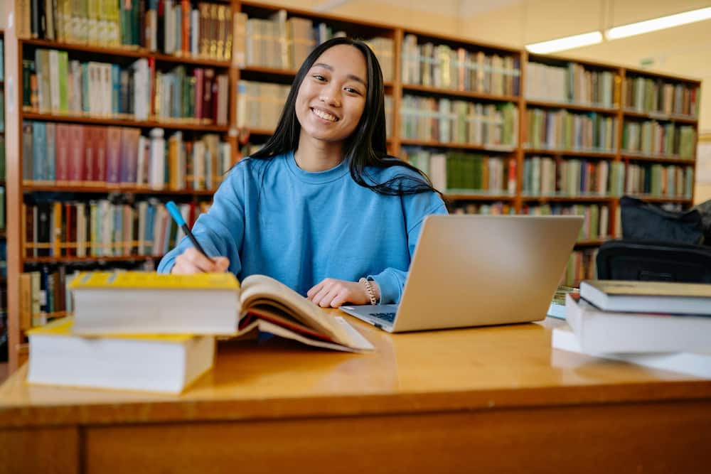 A happy student studying in the library