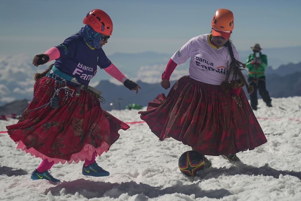 Cecilia Llusco (left) and Senobia Llusco vie for the ball in a high altitude football match after climbing the imposing 6.088-metre Huayna Potosi mountain