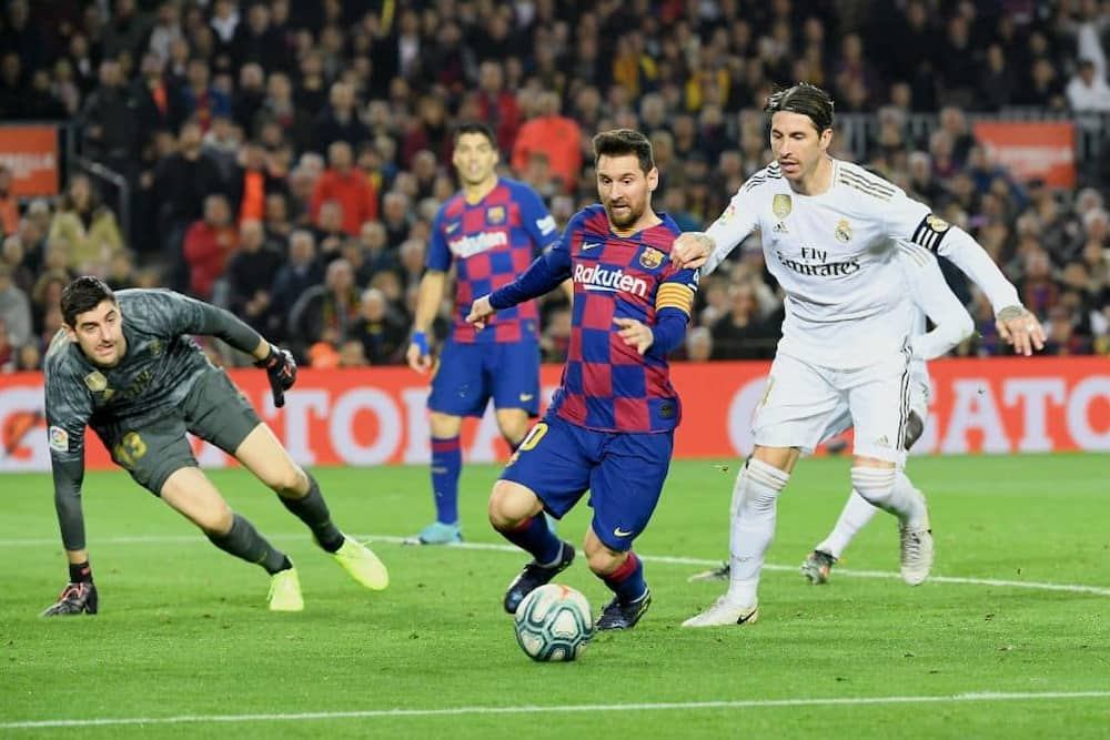 Sergio Ramos in action against Lionel Messi. Photo by LLUIS GENE / AFP.