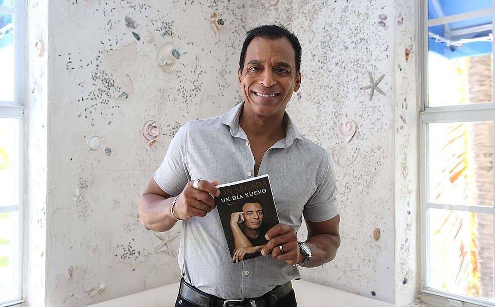 Jon Secada shows off his new book "A New Day at Larios On The Beach"