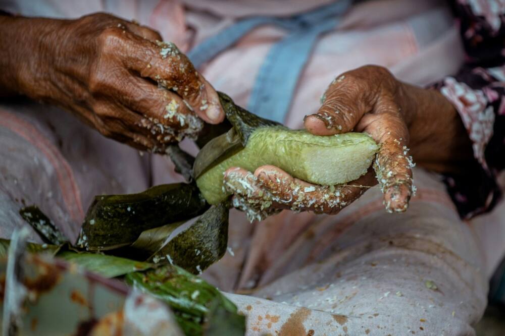 Lupis, a traditional sweet dish, is made from glutinous rice and served with grated coconut and liquid palm sugar