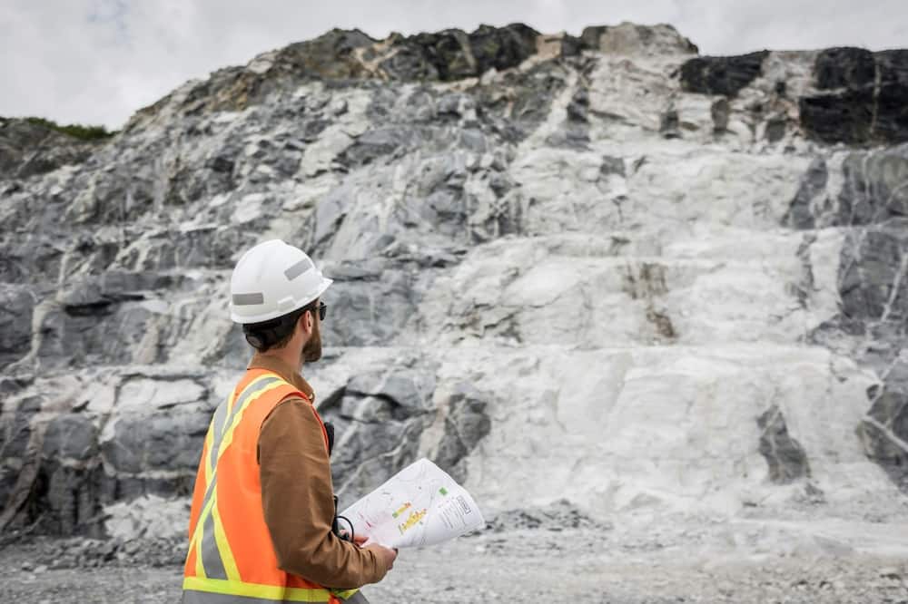 This handout picture provided by Sayona Quebec shows an employee in front of a lithium deposit at the company's lithium complex in La Corne, Quebec