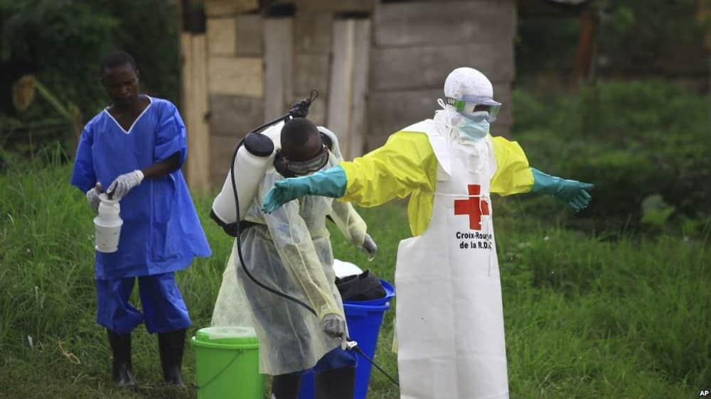 A health worker sprays disinfectant on his colleague during Ebola vaccination exercise in Democratic Republic of Congo.Photo/Citizen