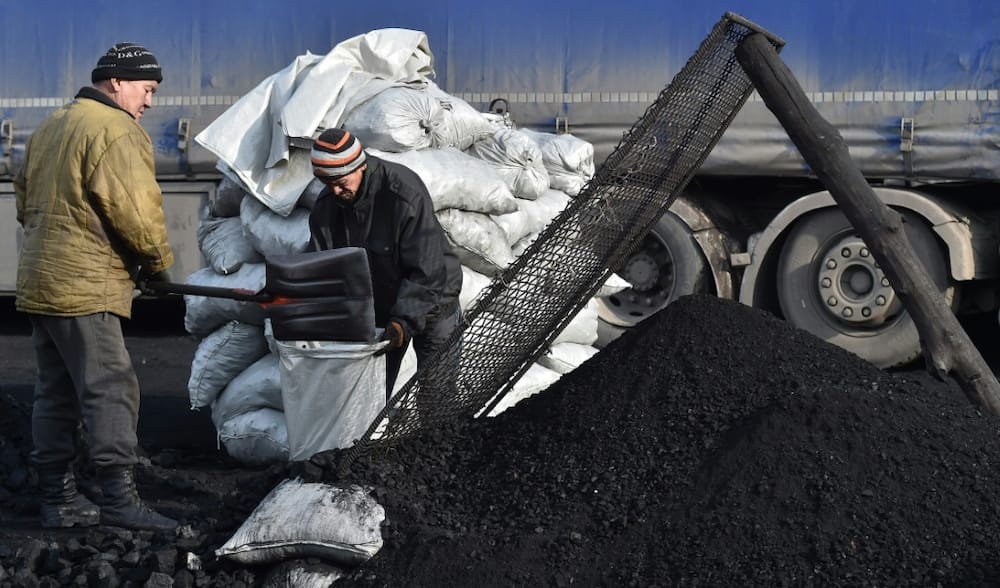 Workers fill bags of coal at Suluktu, the mining town that once heated Central Asia