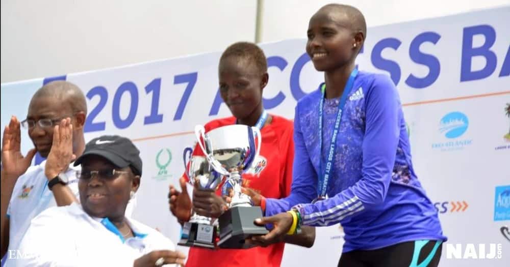 Rhoda Jepkhorir of Kenya, first female runner at the Lagos city marathon is also presented with her trophy